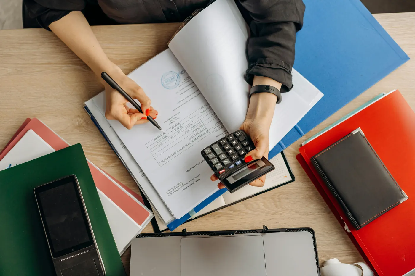 Billing documents and calculator on a desk