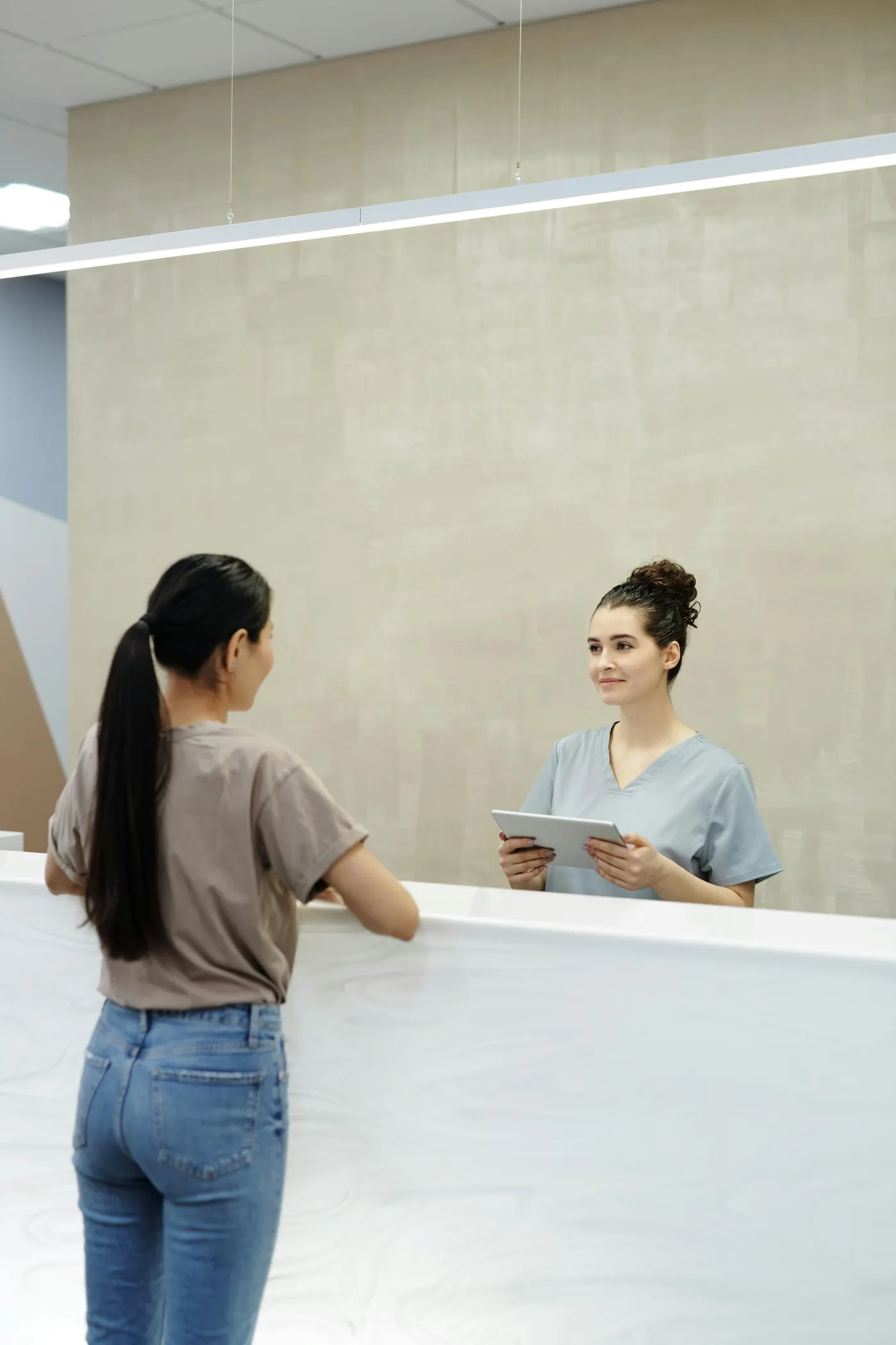 Patient arriving at a private healthcare practice reception desk