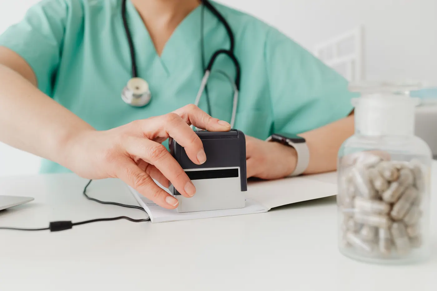 Practice staff stamping patient intake paperwork