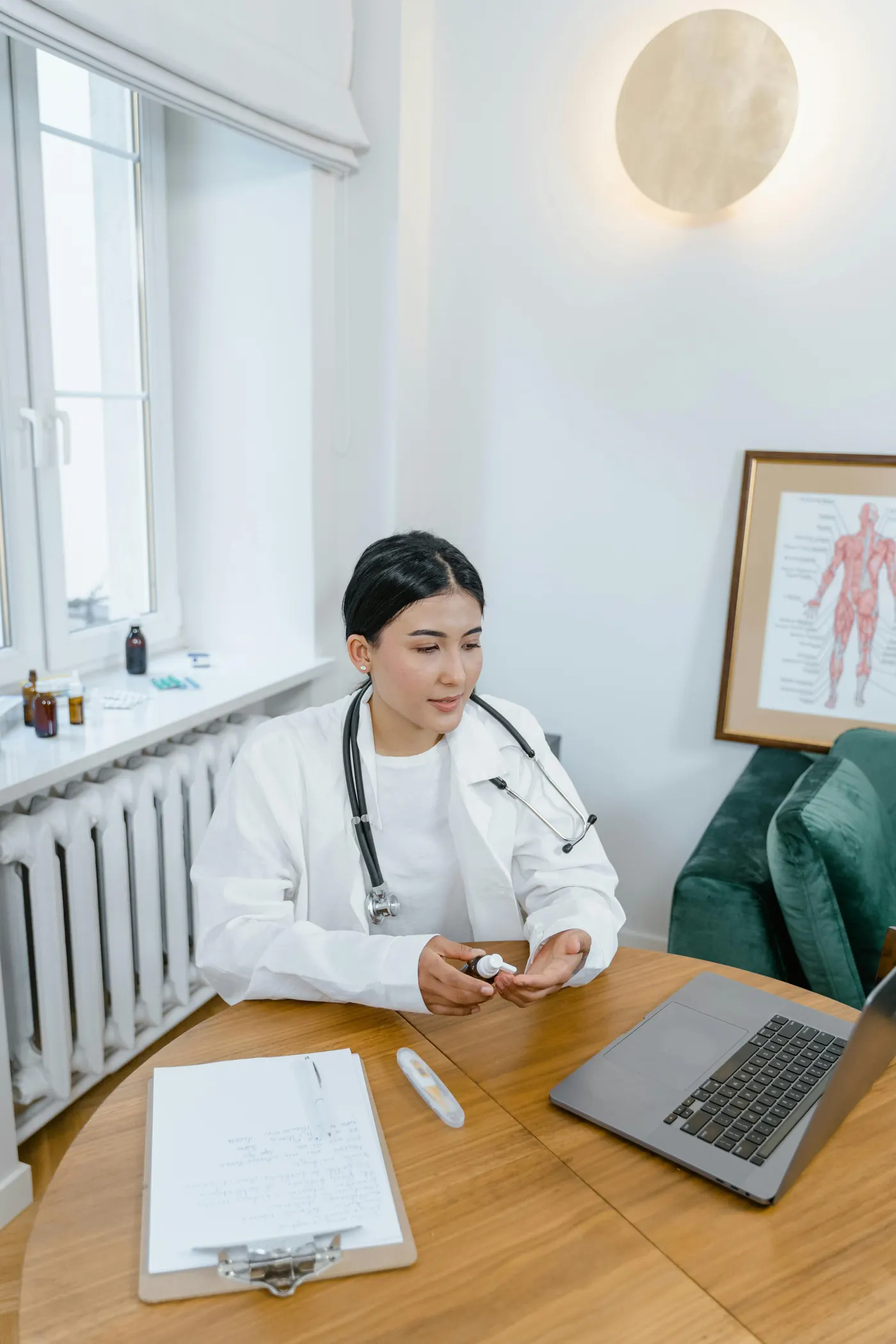 Doctor reviewing patient records on a laptop