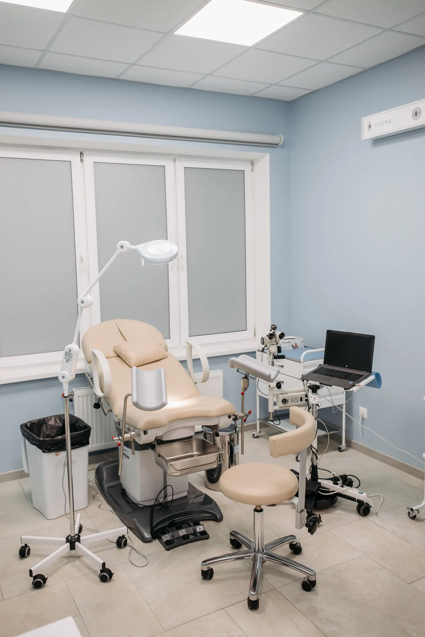 Procedure room with a laptop beside clinical equipment