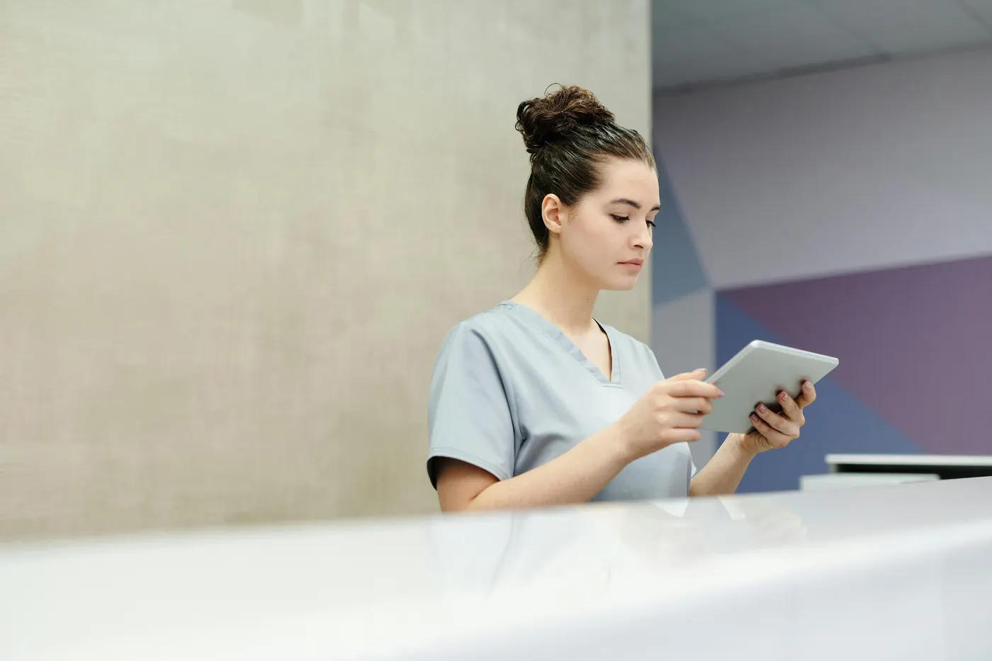 Receptionist managing appointments on a tablet
